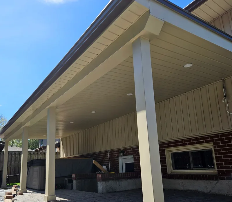 Light-coloured soffit, fascia and trimmed columns around a covered patio on a JerPro Construction project